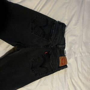 Black cropped  Levi’s with hole in knee size 28